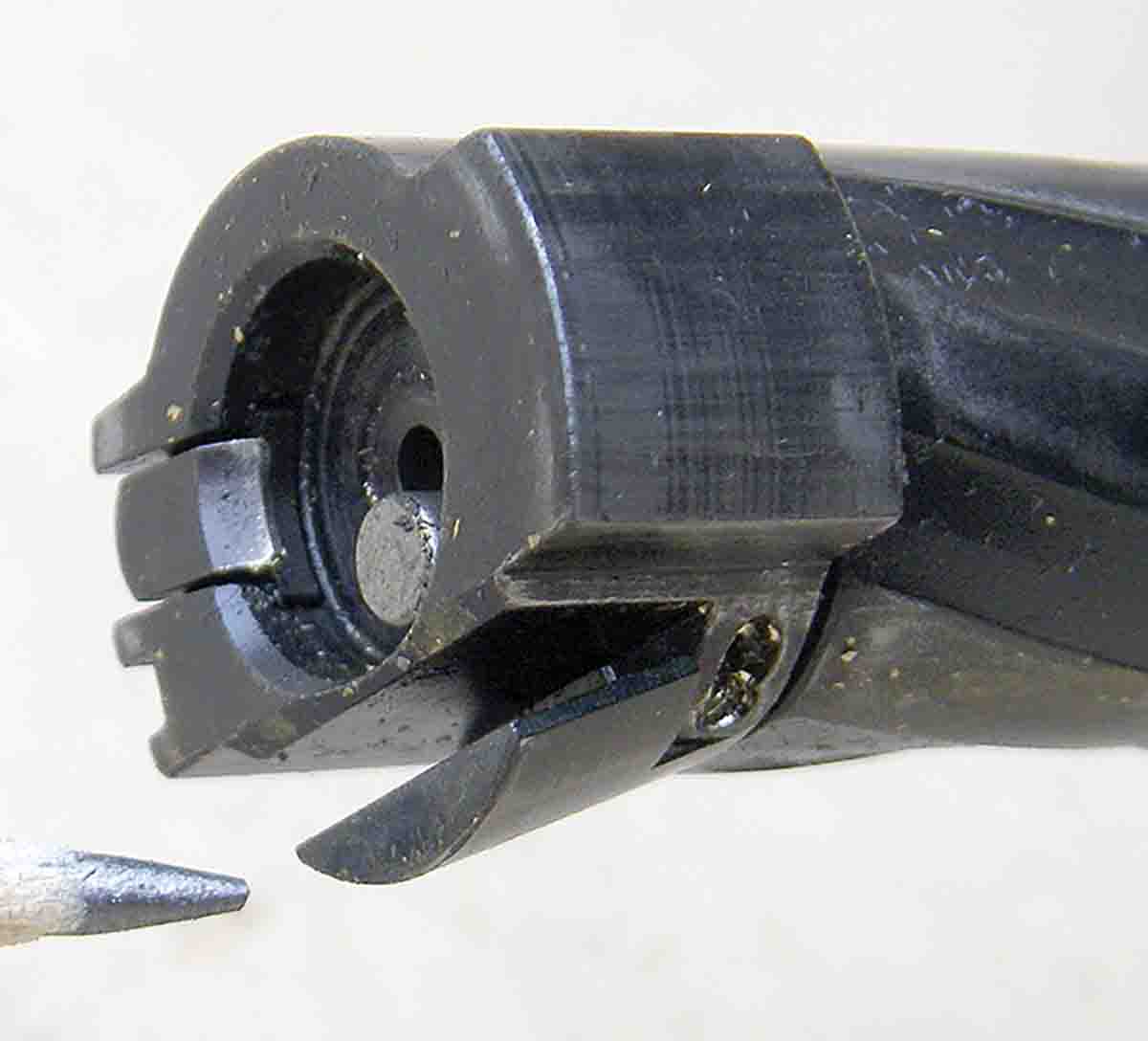 The bolt face is countersunk and features a push-feed system. Note the hinged “cartridge pusher” that strips cartridges from the magazine.